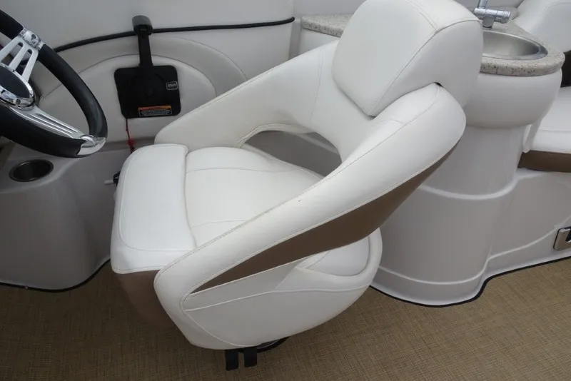 Slide: The Image of Captain's chair in 2008 Four Winns H260 boat, featuring white and brown upholstery. - 14
