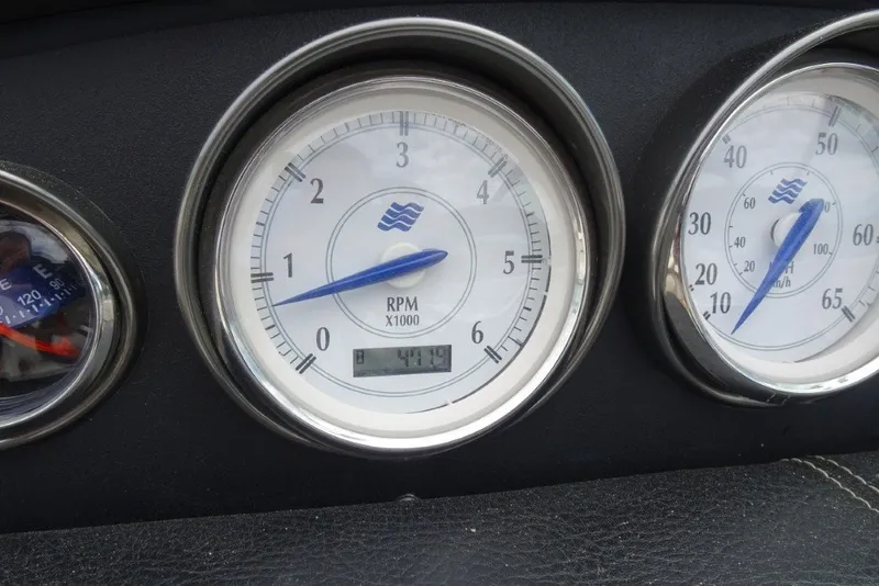 Slide: The Image of Dashboard gauges of a 2008 Four Winns H260 boat, displaying RPM and speed. - 17