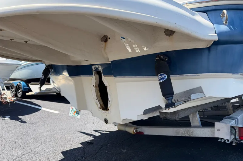 Slide: The Image of 2003 Sea Ray 240 Sundeck boat on trailer, rear view showing hull and outdrive area. - 2