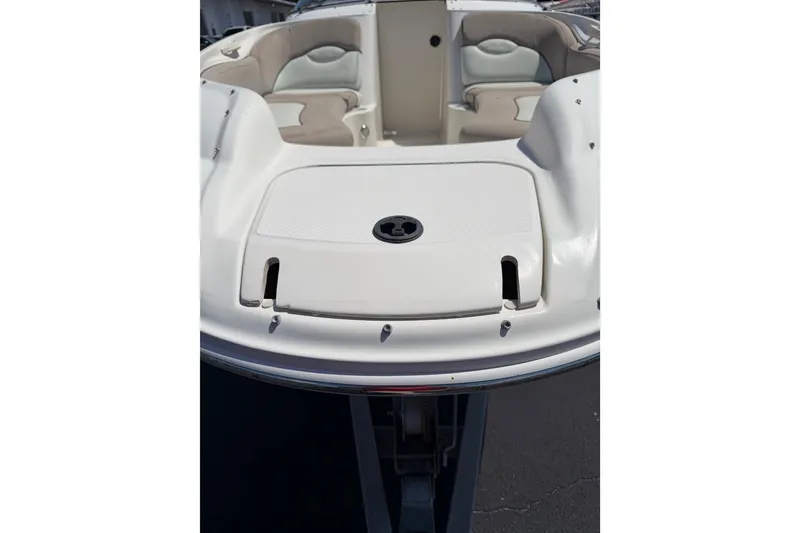 Slide: The Image of 2003 Sea Ray 240 Sundeck boat interior with seating and storage compartment. - 14