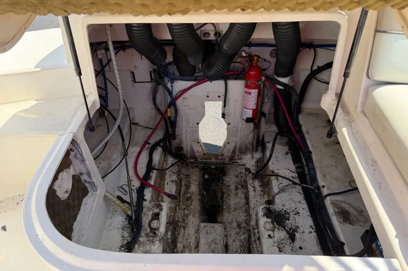 Slide: The Image of Open engine compartment of a 2003 Sea Ray 240 Sundeck boat, showing wiring and fire extinguisher. - 9