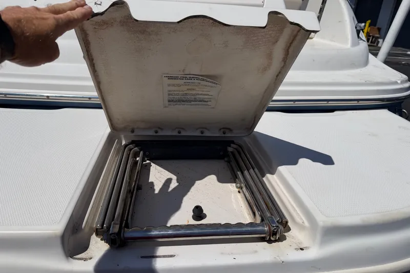 Slide: The Image of Open hatch on a 2003 Sea Ray 240 Sundeck boat, revealing storage compartment. - 3