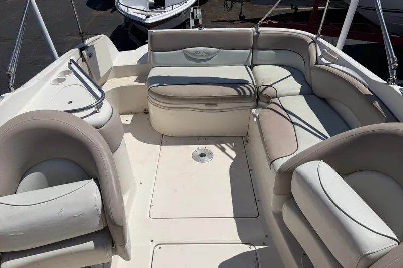 Slide: The Image of 2003 Sea Ray 240 Sundeck interior with spacious seating and white upholstery. - 4