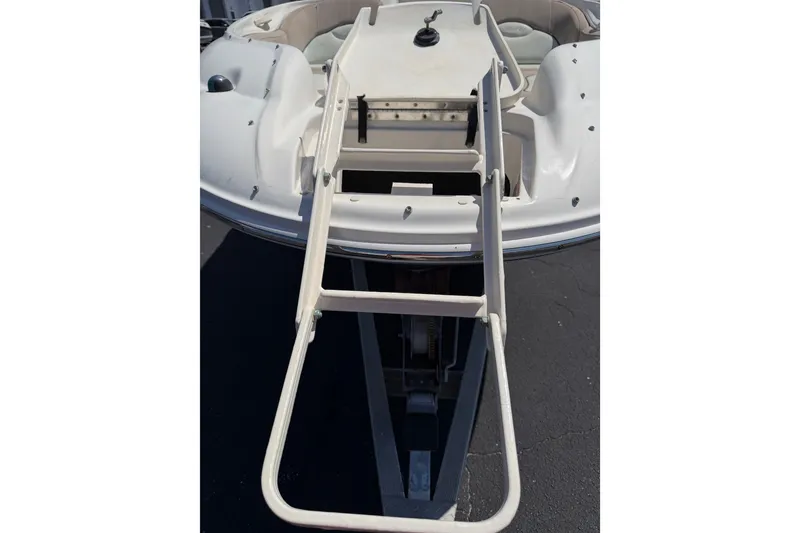 Slide: The Image of 2003 Sea Ray 240 Sundeck boat with extended boarding ladder. - 13