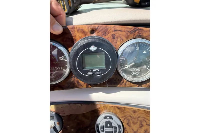 Slide: The Image of Dashboard of a 2003 Sea Ray 240 Sundeck boat with gauges and controls. - 11