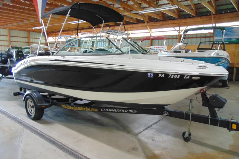 Slide: The Image of 2016 Chaparral 19 H2O Sport boat on trailer in indoor showroom. - 2