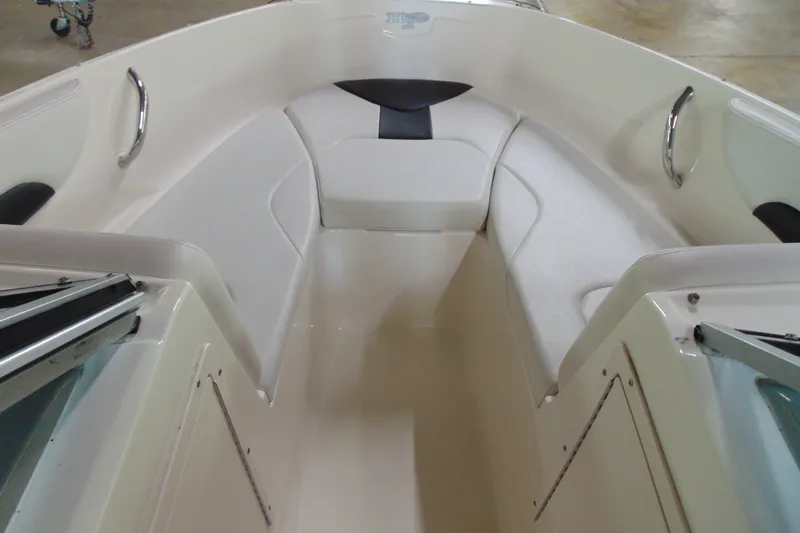 Slide: The Image of 2016 Chaparral 19 H2O Sport boat interior with white seating and stainless steel handles. - 10