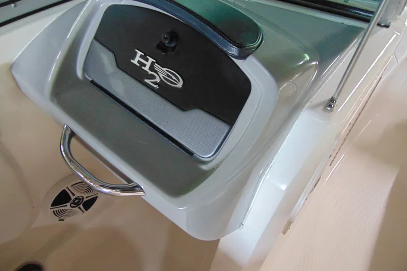 Slide: The Image of 2016 Chaparral 19 H2O Sport dashboard detail with H2O logo and speaker. - 11