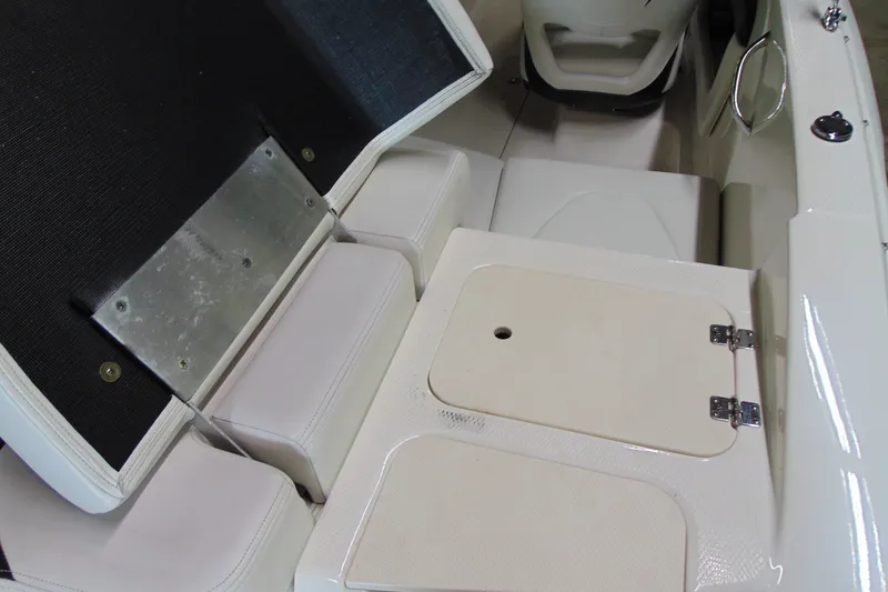 Slide: The Image of 2016 Chaparral 19 H2O Sport boat interior with storage compartments and seating. - 6