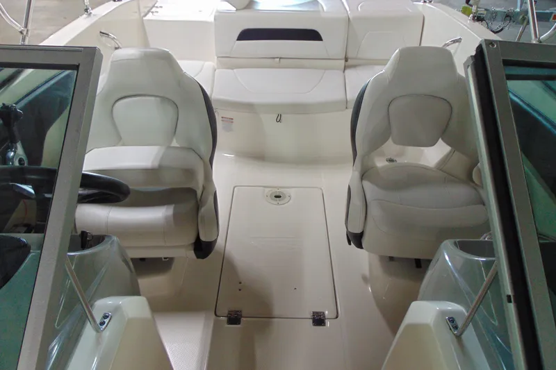 Slide: The Image of 2016 Chaparral 19 H2O Sport boat interior with white seating and steering console. - 16