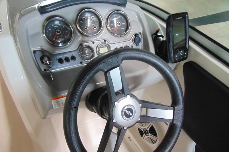 Slide: The Image of Steering console of 2016 Chaparral 19 H2O Sport boat with gauges and Garmin device. - 9