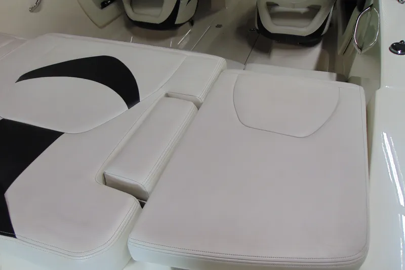 Slide: The Image of 2016 Chaparral 19 H2O Sport boat interior with white cushioned seating. - 5