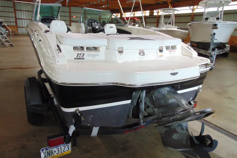 Slide: The Image of 2016 Chaparral 19 H2O Sport boat in a storage facility, rear view. - 4