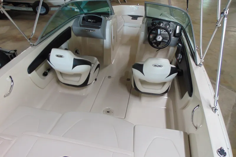 Slide: The Image of 2016 Chaparral 19 H2O Sport boat interior with dual seating and steering console. - 7