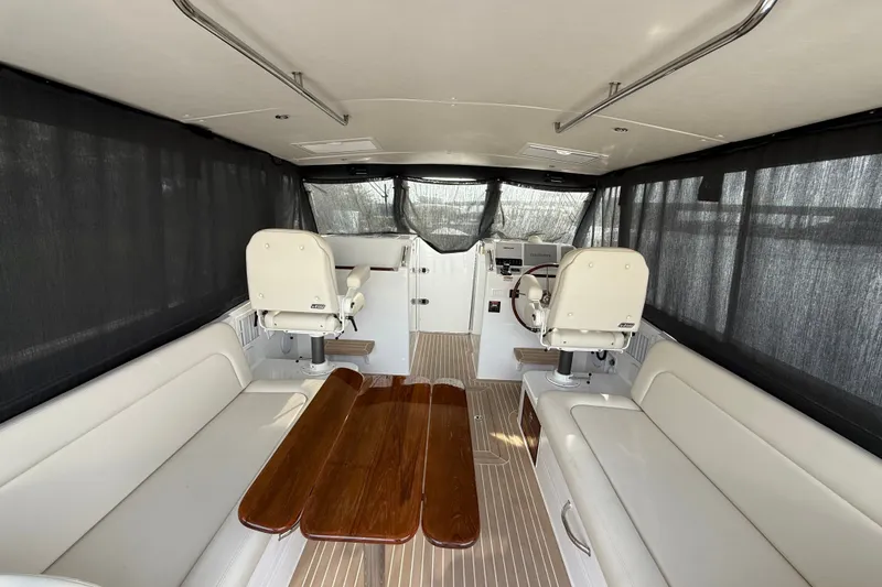 Slide: The Image of Interior of 2024 MJM Yachts MJM 3, featuring elegant seating and a wooden table. - 47