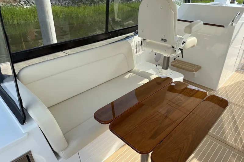Slide: The Image of 2024 MJM Yachts MJM 3 interior with white seating and polished wooden table. - 30