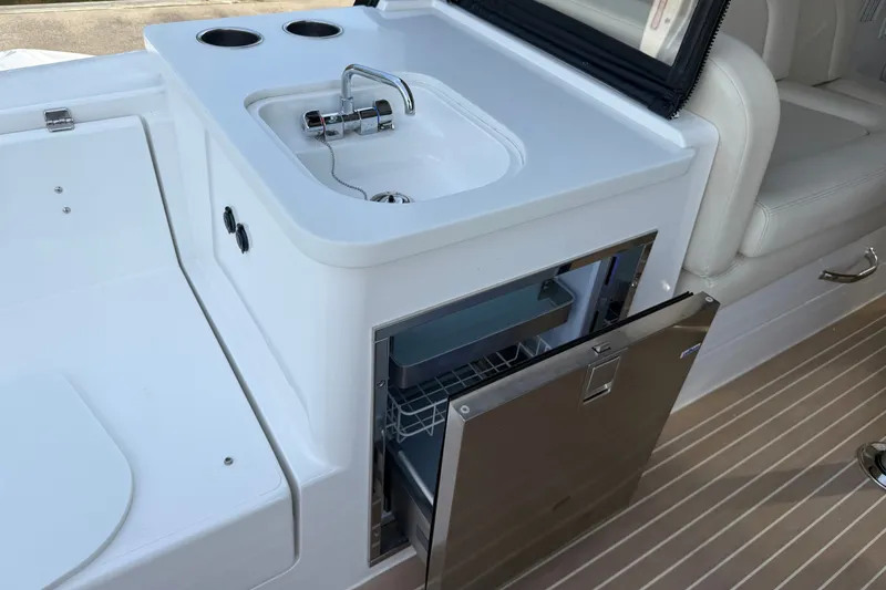 Slide: The Image of 2024 MJM Yachts MJM 3 interior with sink and open refrigerator. - 18