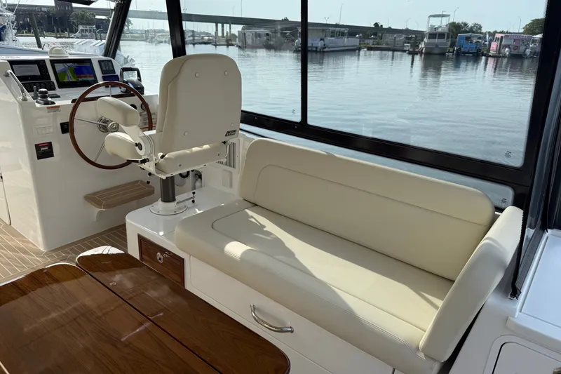 Slide: The Image of 2024 MJM Yachts MJM 3 interior with helm, seating, and waterfront view. - 22