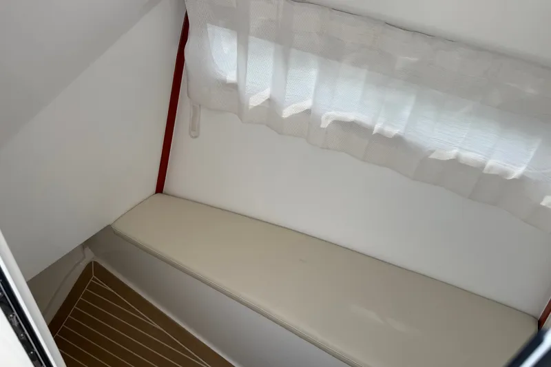 Slide: The Image of Interior cabin of 2024 MJM Yachts MJM 3 with cushioned seating and window curtain. - 35