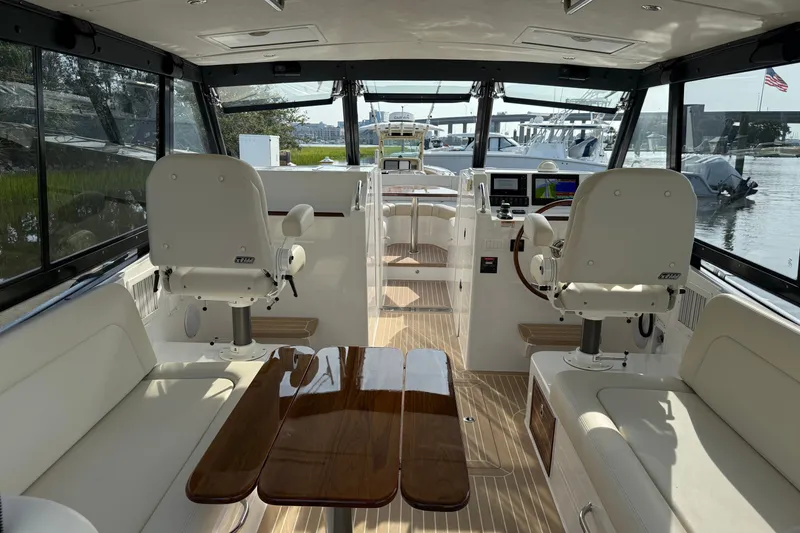 Slide: The Image of Interior view of 2024 MJM Yachts MJM 3, featuring luxurious seating and helm station. - 20