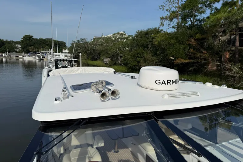 Slide: The Image of 2024 MJM Yachts MJM 3 with Garmin equipment, docked in a serene marina setting. - 42