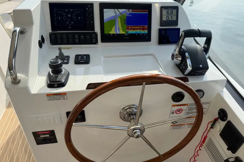 Slide: The Image of 2024 MJM Yachts MJM 3 helm with navigation screens and controls. - 24