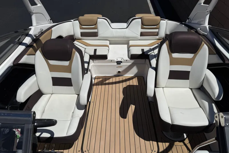 Slide: The Image of 2022 Yamaha Boats 212S interior with stylish seating and teak flooring. - 17