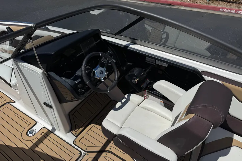 Slide: The Image of Interior view of 2022 Yamaha Boats 212S, featuring steering wheel and seating. - 23