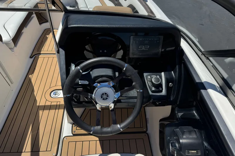 Slide: The Image of 2022 Yamaha Boats 212S steering console with digital display and sleek design. - 24