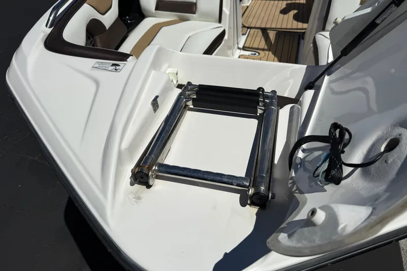 Slide: The Image of 2022 Yamaha Boats 212S swim platform with retractable ladder and seating area. - 13
