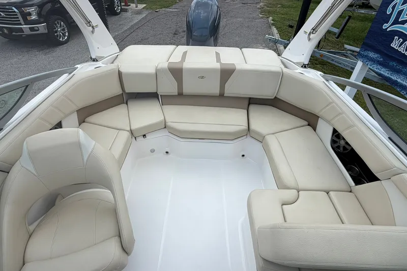 Slide: The Image of 2018 Regal 2100 boat interior with beige seating and spacious layout. - 8