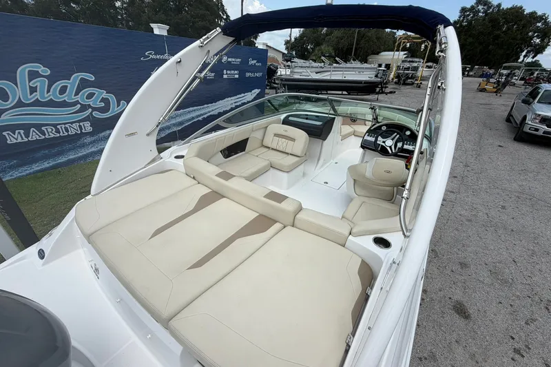 Slide: The Image of 2018 Regal 2100 boat with spacious seating and modern dashboard, displayed at a marine dealership. - 14