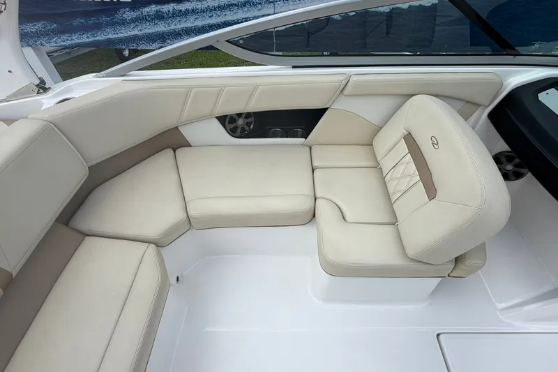 Slide: The Image of Interior of a 2018 Regal 2100 boat featuring beige seating and modern design. - 9