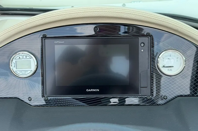 Slide: The Image of Dashboard of a 2018 Regal 2100 boat featuring Garmin GPS and fuel gauge. - 6