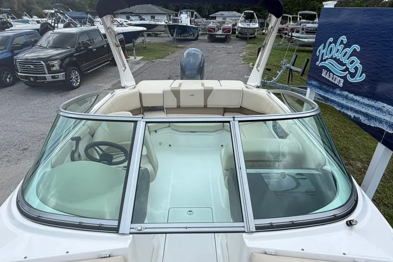 Slide: The Image of 2018 Regal 2100 boat at Holiday Marine dealership, showcasing sleek design and spacious seating. - 3