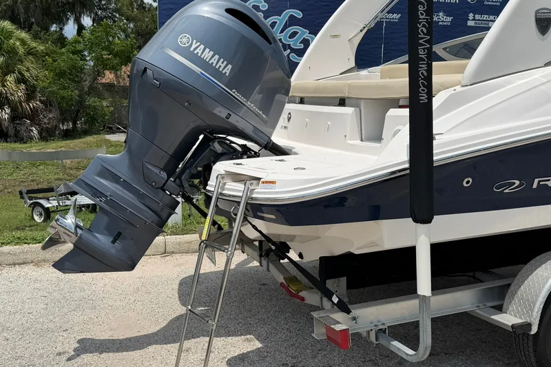 Slide: The Image of 2018 Regal 2100 boat with Yamaha outboard motor on a trailer. - 17