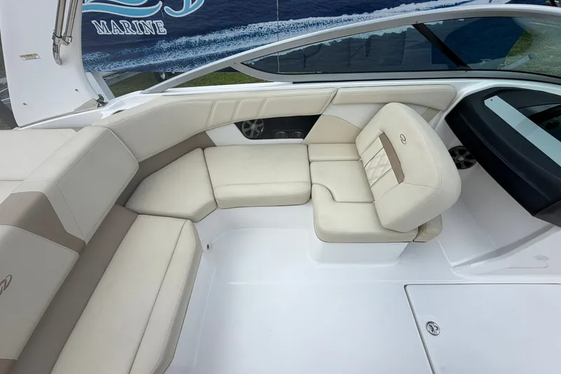 Slide: The Image of 2018 Regal 2100 boat interior with beige seating and sleek design. - 10