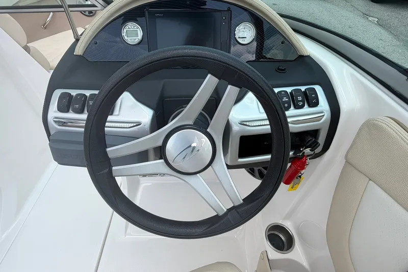 Slide: The Image of Steering wheel and dashboard of a 2018 Regal 2100 boat. - 5