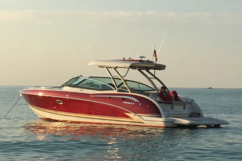 Slide: The Image of 2016 Formula 350 Crossover Bowrider I/O on calm water at sunset. - 15