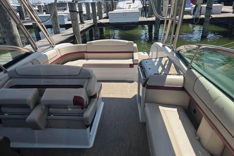 Slide: The Image of 2016 Formula 350 Crossover Bowrider I/O interior with spacious seating at marina. - 13