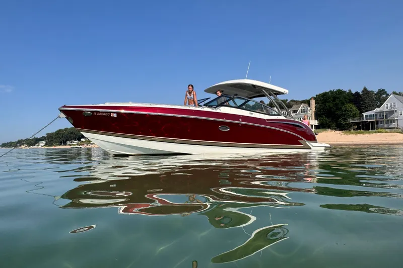The Image of 2016 Formula 350 Crossover Bowrider I/O on calm water near a sandy beach. - 0