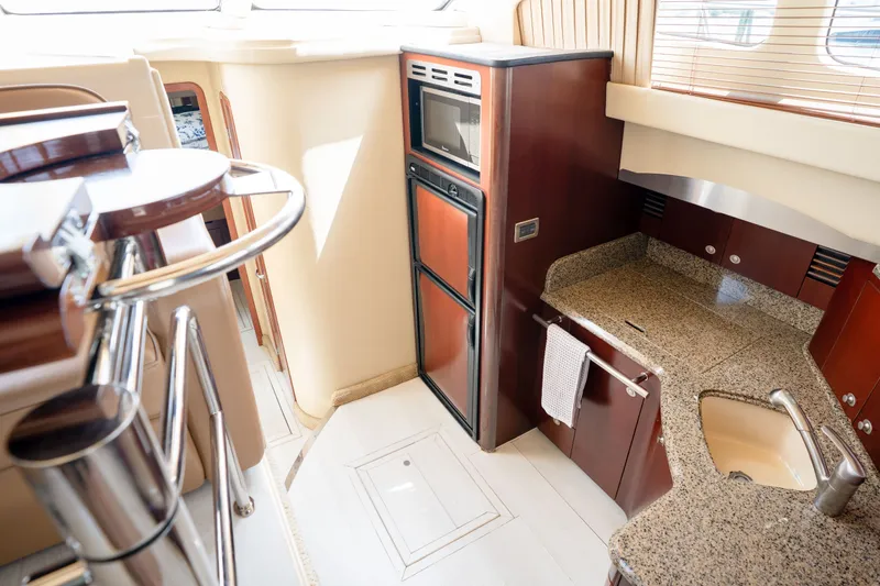Slide: The Image of Luxurious kitchen interior of 2006 Sea Ray 44 Sedan Bridge yacht with granite countertops. - 31
