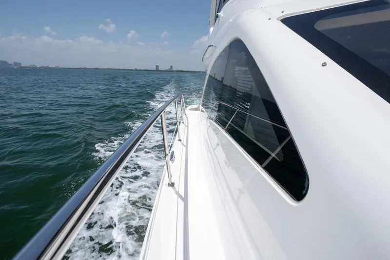 Slide: The Image of 2006 Sea Ray 44 Sedan Bridge cruising on open water, side view. - 12