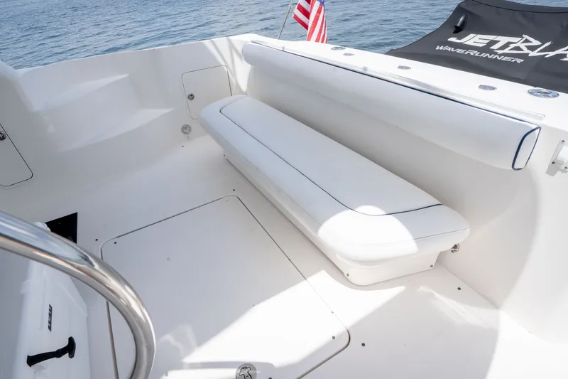 Slide: The Image of 2006 Sea Ray 44 Sedan Bridge boat deck with white seating and American flag. - 10