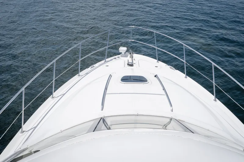 Slide: The Image of Bow view of 2006 Sea Ray 44 Sedan Bridge yacht on open water. - 16