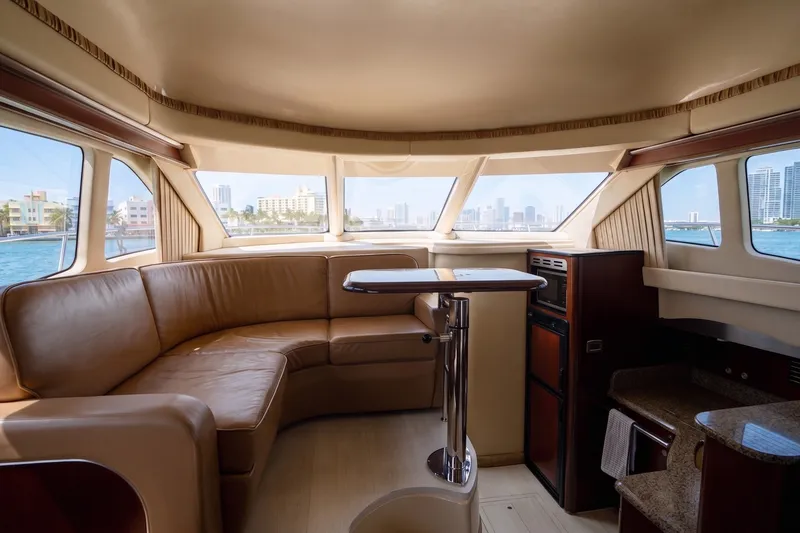 Slide: The Image of Luxurious interior of a 2006 Sea Ray 44 Sedan Bridge yacht with panoramic windows. - 30
