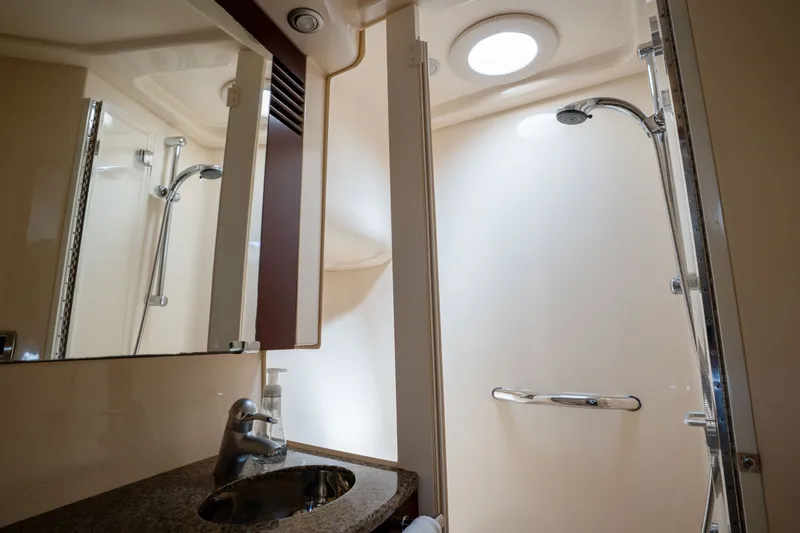 Slide: The Image of Luxurious bathroom interior of 2006 Sea Ray 44 Sedan Bridge yacht with shower and sink. - 34