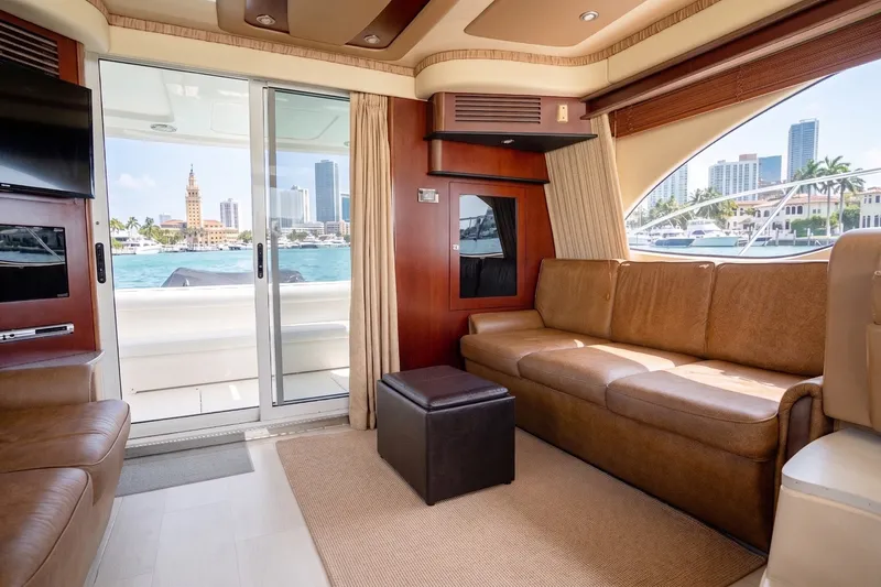 Slide: The Image of Luxurious interior of 2006 Sea Ray 44 Sedan Bridge yacht with city skyline view. - 25
