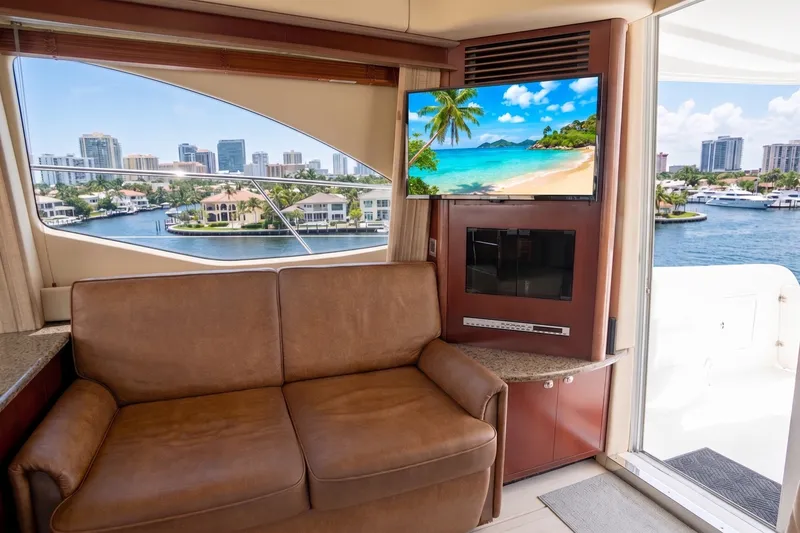 Slide: The Image of Interior of 2006 Sea Ray 44 Sedan Bridge yacht with waterfront view and TV. - 26