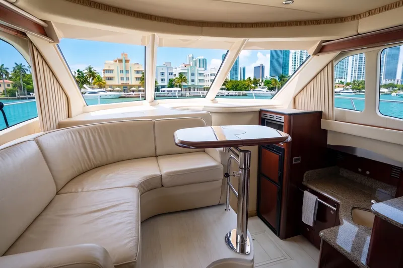 Slide: The Image of Luxurious interior of a 2006 Sea Ray 44 Sedan Bridge yacht with cityscape view. - 28